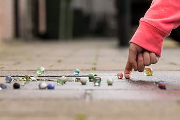 kids played marbles on the sidewalk